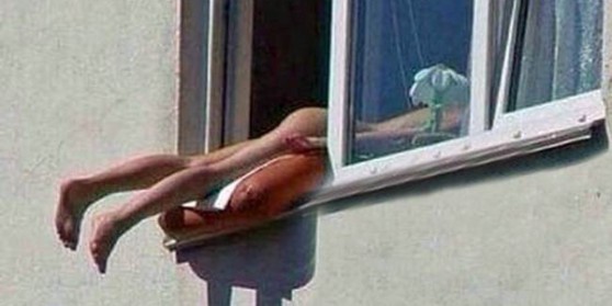 Woman Sunbathes Naked Out of Window, Causes Cars to Crash