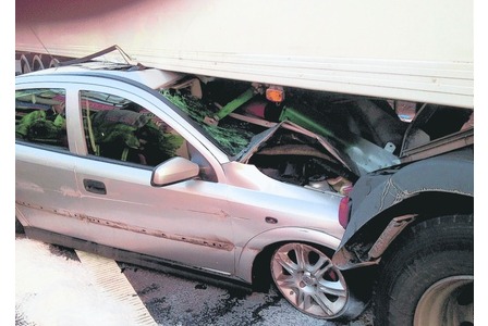 Miracle motorist: Car is wedged underneath lorry and dragged along motorway... yet driver walks away with minor injuries