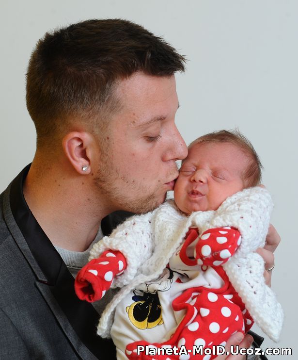 Heartbroken husband cuddles baby his wife never saw - after she died giving birth